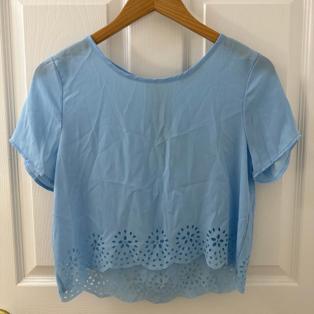 Light blue crop top with silver zipper back laser cut floral details scalloped